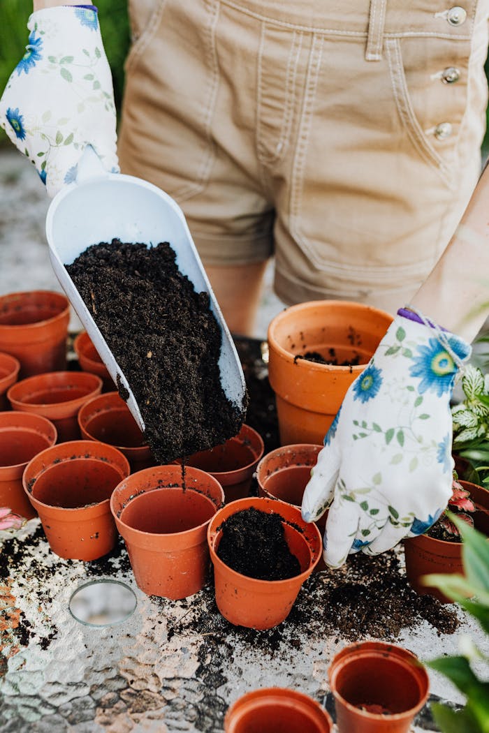 The Art of Drawing Readers In: Your attractive post title goes here Close-up of soil being placed in clay pots with floral gloves, ideal for gardening themes.